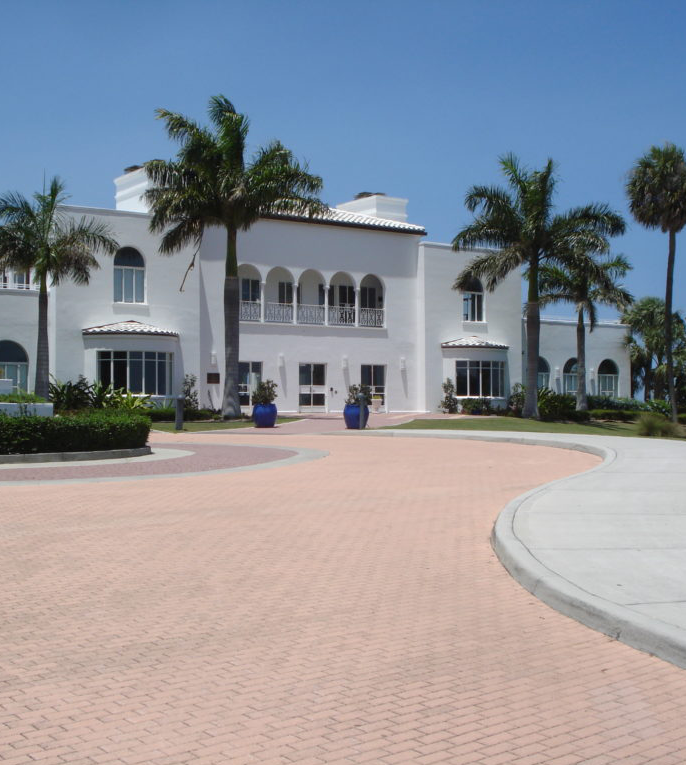 Beautiful coastal-style home in Jensen Beach, FL, surrounded by tropical landscaping, showcasing the charm of homes for sale in Jensen Beach, FL